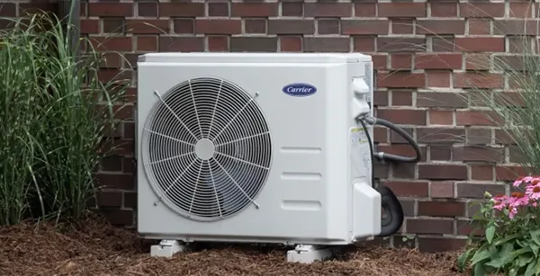 Carrier ductless air conditioner unit mounted outside a home for energy-efficient cooling